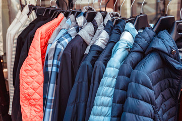 Set of row warm autumn clothing on hangers. Sale shopping concept.