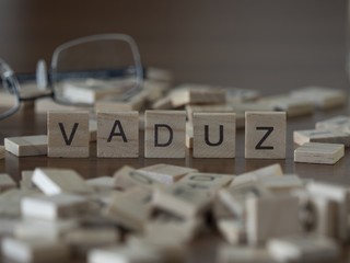 The European capital city name Vaduz represented by wooden letter tiles 