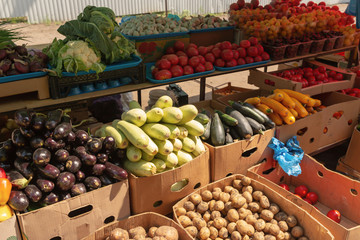 Fresh, ripe vegetables, fruits and berries are on the trading table in the market. Dietary food.