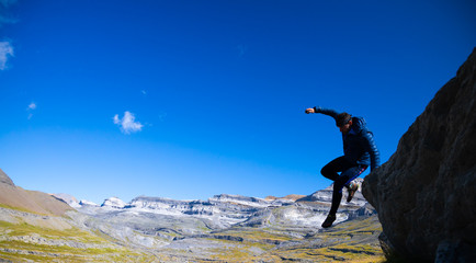 Hombre deportista saltando y corriendo en la montaña