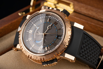 wrist watch packed in open wooden box. roman dial