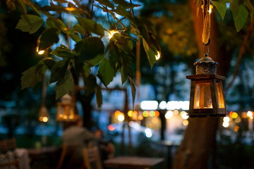 Naklejka premium Restaurants and bars on evening streets. Lights of the evening city, calm evening of a business day