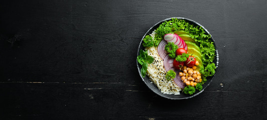 Vegan, detox Buddha bowl recipe with rice, avocado, tomatoes and chickpeas. Dishes menu. Free copy space. Top view.