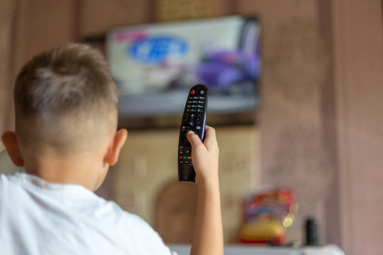 Small boy and TV remote control