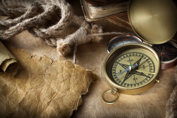 compass and rope on old map