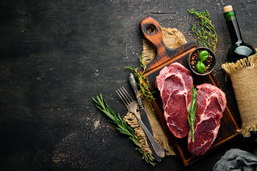 Raw marbled meat Black Angus Steak Ribeye. At the aged table. Top view. Free space for your text.