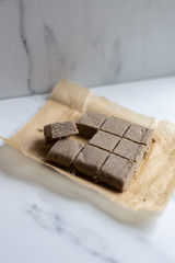Portion of halva with vanilla and sunflower seeds on marble background with copy space