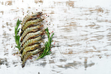 black tiger prawns with lemon. Seafood. Top view. On a white wooden background. Free copy space.