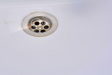 drain hole in the sink. Water seeps into the drain hole in the sink. Close-up, copy space.