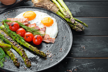 Breakfast. Asparagus, eggs, bacon and cherry tomatoes. Healthy food. Top view. Free space for your text.