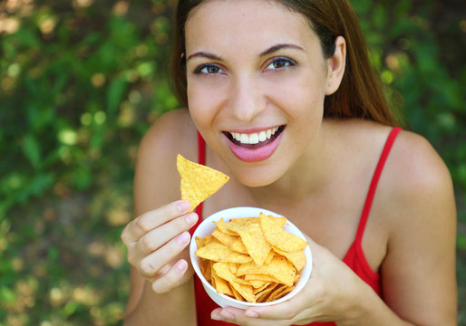 Beautiful Young Woman Eating Tortilla Chips Outdoor.