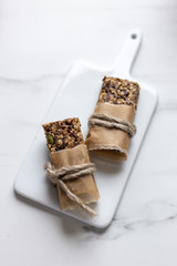Granola bar. Healthy snack on marble background with copy space
