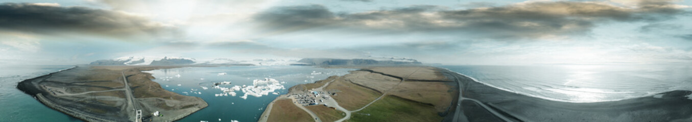 Jokullsarlon glacial lake in southwest Iceland. Panoramic aerial view of icebergs in the lagoon at sunset