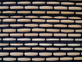 Bamboo woven with black fabric, textured surface
