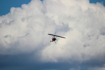 Fototapeta na wymiar Motorized glider in the clouds