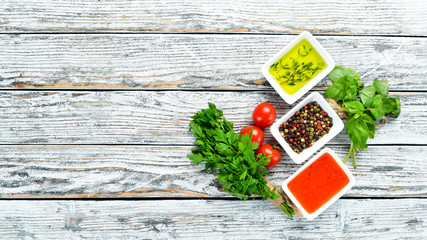 Set sauces and spices. On a wooden background. Top view. Free space for your text.
