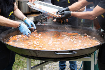Men cooking paella