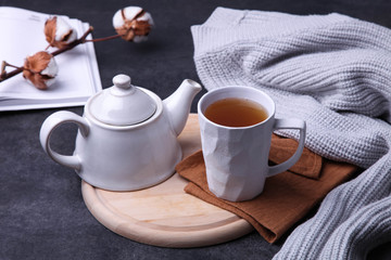 Fototapeta na wymiar Cup of hot tea and teapot