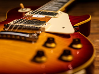 electric guitar body close-up view is on the wood floor