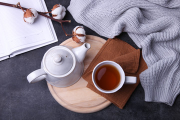 Cup of hot tea and teapot