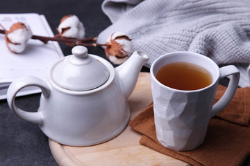 Cup of hot tea and teapot