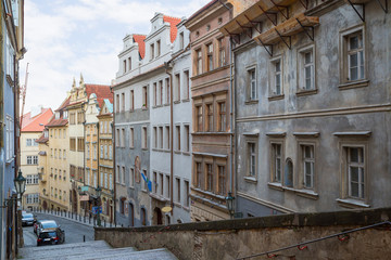 Empty stairs to the Prague Castle and old buildings along the Thunovska street at the Mala Strana (Lesser Town) district in Prague, Czech Republic.