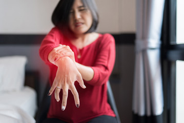 Woman suffering with parkinson's disease symptoms,Selective focus hands