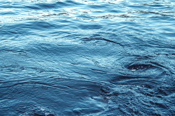 Close up photo of small whirlwinds, swirls in the ocean water. Blue colors and nice lightning. Swirls from boat motor. - 285001589