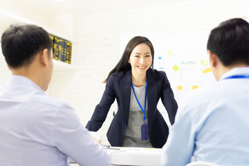 Fototapeta premium Portrait of businesswoman feeling happy in a busy modern office.