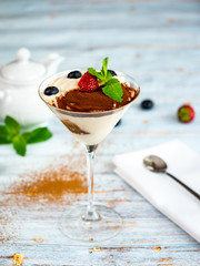 Tiramisu dessert in a glass. Restaurant serving.
