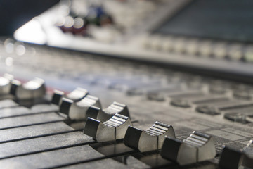 Close-up of mixing console, music equalizer in sound recording Studio
