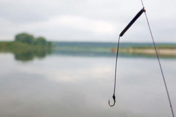 Fishing hook on water and fishes on the river