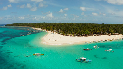 Seascape with beautiful beach and tropical island palm trees by coral reef from above. Daco island, Philippines. Summer and travel vacation concept