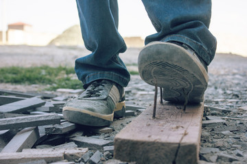Worker steps on nail outdoors