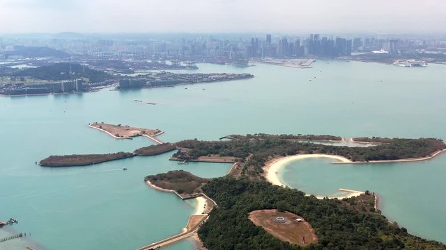 Aerial, rising, drone shot, overlooking the Lazarus, St Johns and Seringat islands, on a sunny day, at a coast of Singapore, Asia