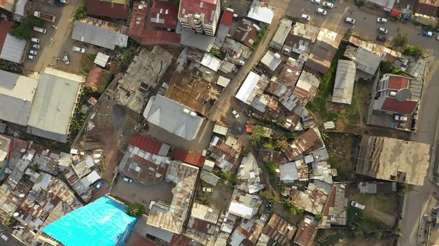 Overhead drone shot flying over rooftops made of corrugated sheets in Addis Ababa, Ethiopia's capital city