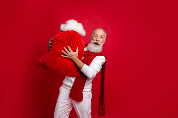 Hipster grey haired man unusual santa with traditionally large bag wear fashion knitted clothes...