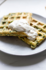 spinach waffles on white marble background with opy space