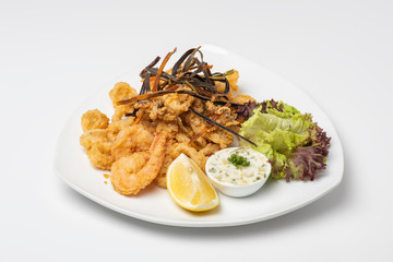 Crispy crunchy breaded crumbs coating Fried Shrimps on white plate, Breaded shrimps plate with tartar sauce isolated on white background