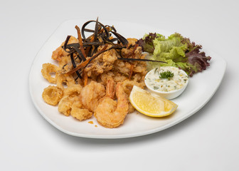 Crispy crunchy breaded crumbs coating Fried Shrimps on white plate, Breaded shrimps plate with tartar sauce isolated on white background