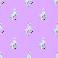 seamless pattern of white unicorns on purple background