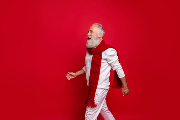 Fototapeta na wymiar Profile side view of his he nice attractive well-dressed gray-haired man walking going motion movement coming December isolated over bright vivid shine red background