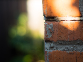 The corner of a brick wall close up