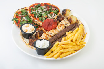 Lebanese Mixed Grill plate isolated on white.