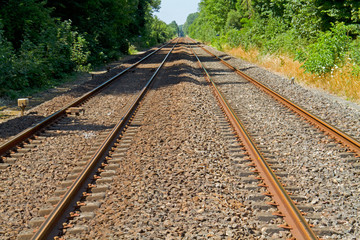 Fototapeta premium Railroad tracks on concrete sleepers and ballast bed
