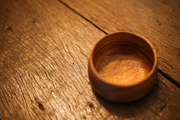 Obraz na płótnie Canvas cup brown wood table a bowl 