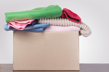 Donation concept. Donation box with donation clothes on a  Charity. Helping poor and needy people.
