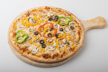 Delicious Vegetarian pizza served on wooden plate isolated on white.