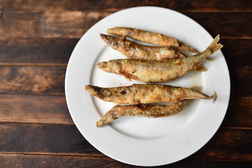 fried battered fish on wooden table top view