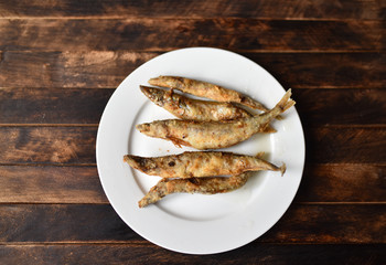 fried battered fish on wooden table top view